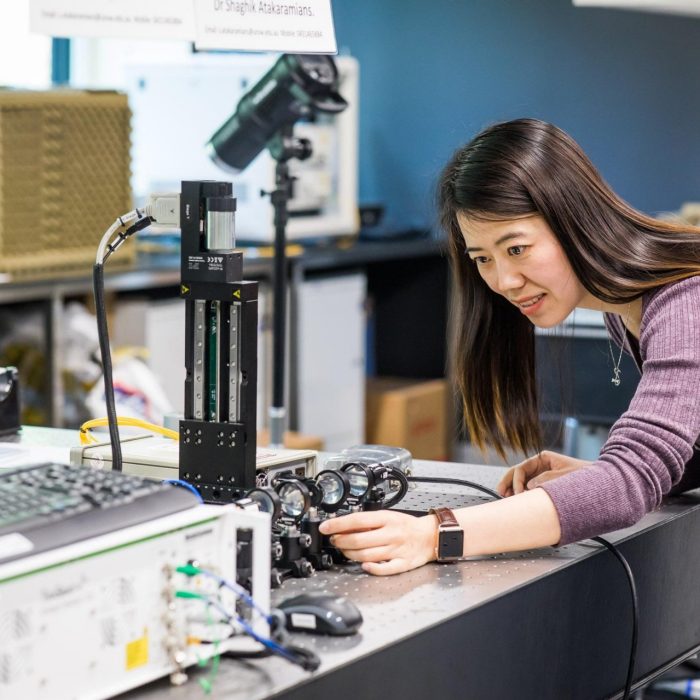 Electrical engineering postgraduate student working in lab