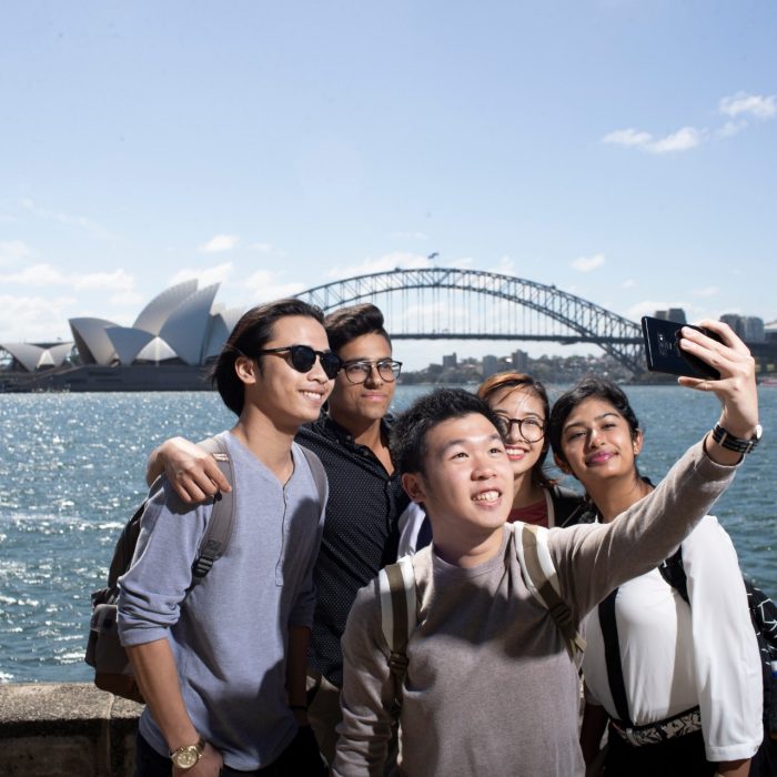 Students taking selfie in front of Sydney Opera House and Harbour Bridge