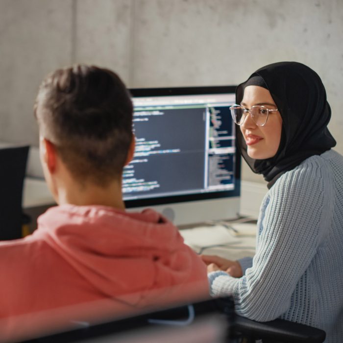 Smart Young Students Studying in University with Diverse Multiethnic Classmates. Scholars Collaborate in College Room on Computer Science Project, Writing Software Code in Successful Teamwork.