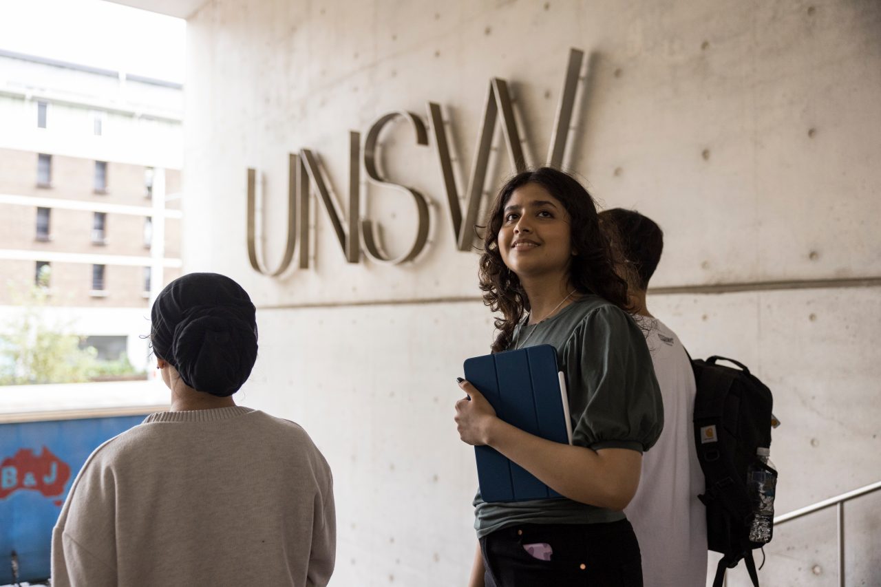 Female student standing in front of UNSW logo on L5 steps